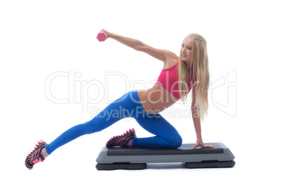 Smiling muscular girl exercising with dumbbells