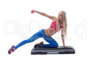 Smiling muscular girl exercising with dumbbells