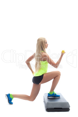 Young athletic model doing aerobics on stepper