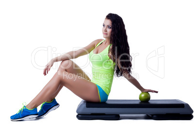 Image of lovely young brunette sitting on stepper
