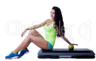 Image of lovely young brunette sitting on stepper