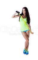 Sexy model in sportswear posing with skipping rope