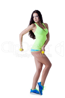 Pretty strong girl posing with dumbbells in studio
