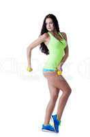 Pretty strong girl posing with dumbbells in studio