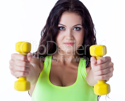 Portrait of smiling sporty woman with dumbbells