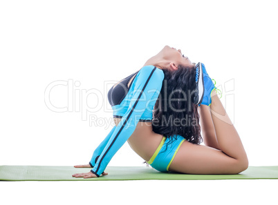 Curly flexible brunette doing gymnastic ring