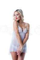 Playful smiling blonde posing in erotic negligee