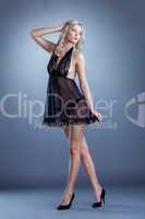 Charming slim girl posing in black lacy negligee