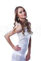 Stylish brunette posing in white slinky dress