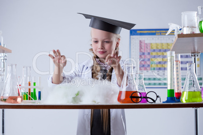 Image of cute chemist conducting experiment in lab