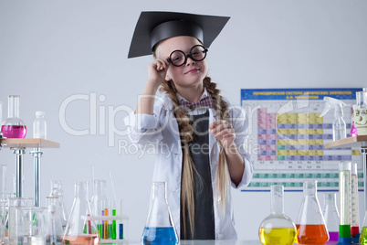 Pretty little scientist posing with glasses in lab