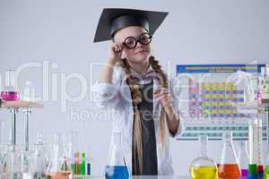 Pretty little scientist posing with glasses in lab