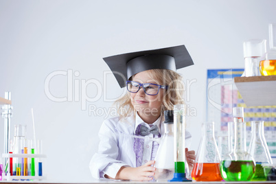 Petite blonde schoolgirl posing in laboratory