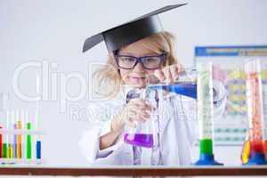 Curious schoolgirl pouring reagent into flask