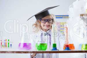 Smiling little chemist puts experiments in lab