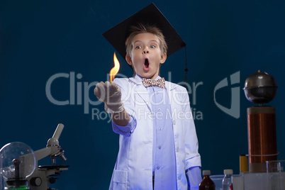 Surprised young physicist posing with fire in lab