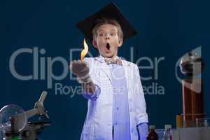 Surprised young physicist posing with fire in lab