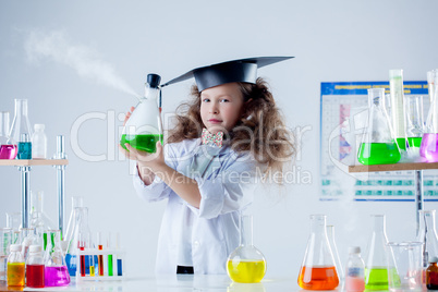 Pretty little brunette posing in chemistry lab