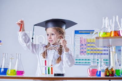 Beautiful little chemist works in laboratory