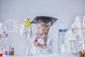 Portrait of inquisitive girl looking at test tube