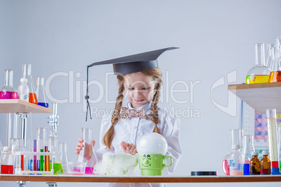 Curious schoolgirl conducting experiment in lab