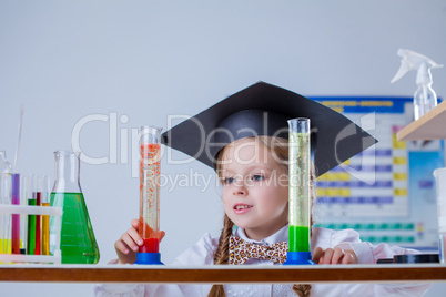 Beautiful little pupil posing with test tubes