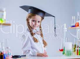 Adorable schoolgirl posing in chemistry class