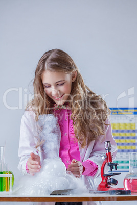 Smiling student looking at reaction of reagents