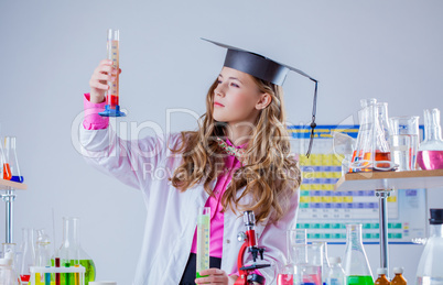 Image of high school girl looking at test tube