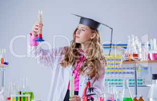 Image of high school girl looking at test tube