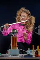 Funny young girl conducting experiments in lab