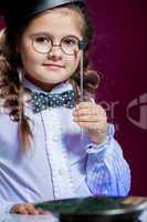 Portrait of lovely little girl posing with glasses