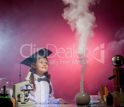 Attentive girl watches evaporation of reagents