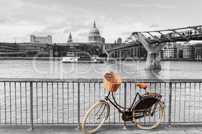 Bike with wicker basket against St Paul's backdrop, London, UK