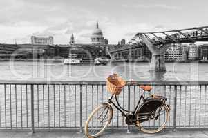 Bike with wicker basket against St Paul's backdrop, London, UK