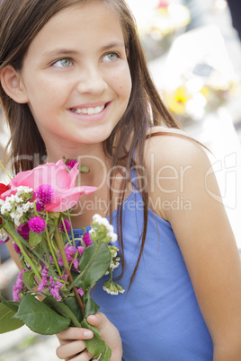 pretty young girl holding flower bouquet at the market