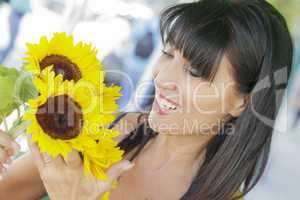pretty italian woman looking at sunflowers at market