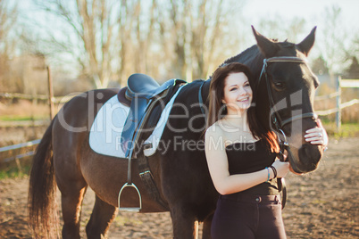 Young woman with a horse on nature