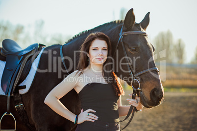 Young woman with a horse on nature