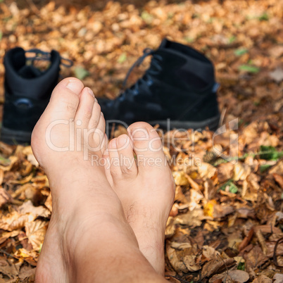 shoes and bare feet in autumn leaves