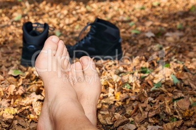 shoes and bare feet in autumn leaves