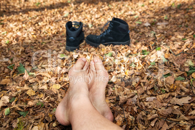 shoes and bare feet in autumn leaves