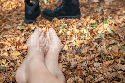 shoes and bare feet in autumn leaves