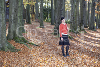 woman alone in autumn forest