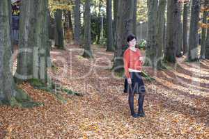 woman alone in autumn forest