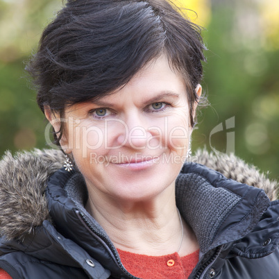 portrait of a middle aged woman in autumn