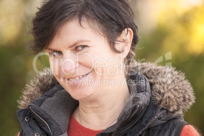 portrait of a middle aged woman in autumn