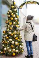woman looks at christmas decorations