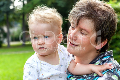 happy mother holds daughter on the arm