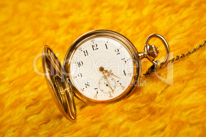 gold pocket watch on gold cover